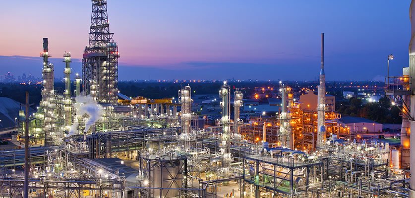 Refinery towers and process units lit at night