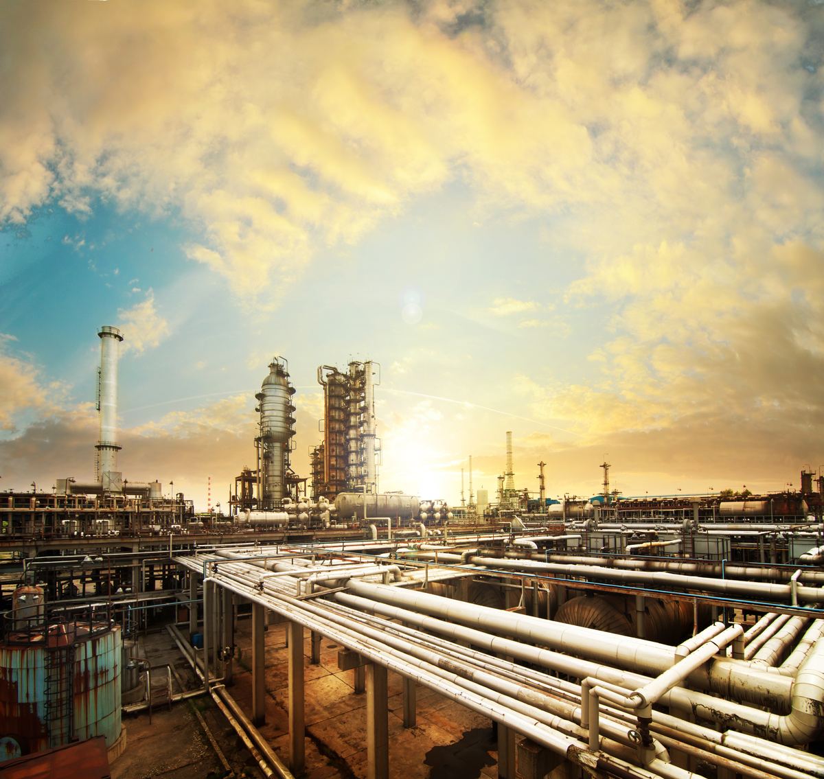 Process piping at an industrial plant at sunset